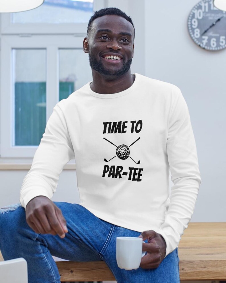 May include: White long-sleeve sweatshirt with black text that reads "Time to Par-Tee" with a golf ball and crossed golf clubs.