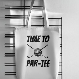 May include: White canvas tote bag with black text that reads "Time to Par-Tee" and a golf ball and crossed golf clubs graphic.