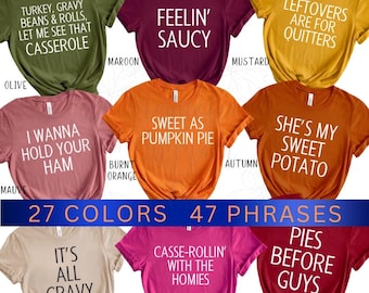 May include: A collage of 10 different t-shirt designs featuring Thanksgiving-themed phrases. The shirts are displayed on a white background and are arranged in two rows of five. The phrases on the shirts include "Turkey, Gravy Beans & Rolls, Let Me See That Casserole", "Feelin' Saucy", "Leftovers Are For Quitters", "I Wanna Hold Your Ham", "Sweet As Pumpkin Pie", "She's My Sweet Potato", "It's All Gravy", "Casse-Rollin' With The Homies", "Pies Before Guys". The shirts are available in a variety of colors, including olive, maroon, mustard, mauve, burnt orange, autumn, tan, berry, and cardinal.