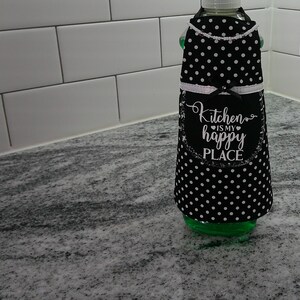 May include: Black and white polka dot dish soap dispenser with a white trim and the text "Kitchen is my happy place".