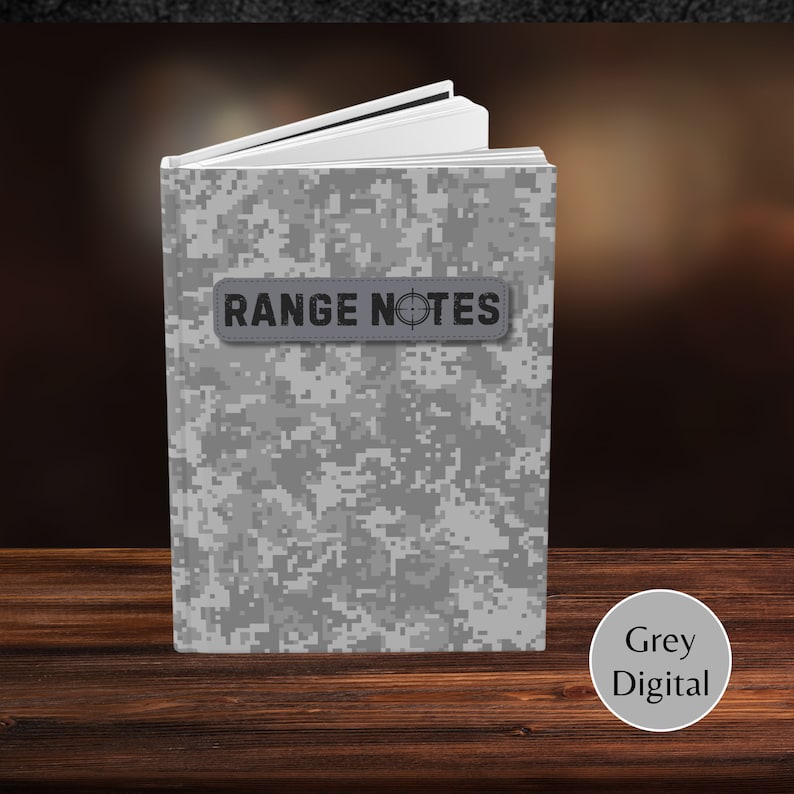 May include: A grey and white digital camouflage notebook with the text "RANGE NOTES" on a grey patch.