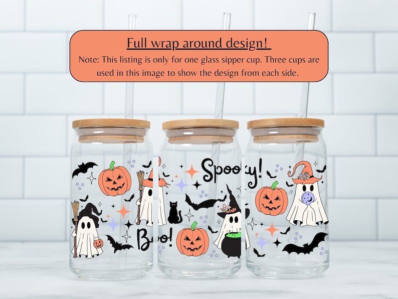 May include: Three glass cups with bamboo lids and straws, featuring a Halloween design with ghosts, bats, pumpkins, and stars. The design wraps around the cups and includes the text "Boo!" and "Spooky!"