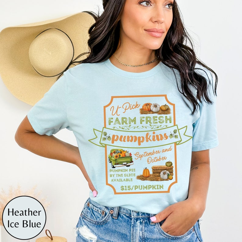 May include: A light blue t-shirt with a graphic of a vintage truck carrying pumpkins. The text on the graphic reads "U-Pick Farm Fresh Pumpkins", "September and October", "Pumpkin Pie by the Slice Available", and "$15/Pumpkin".