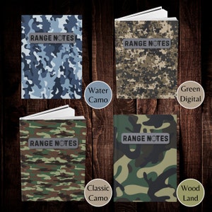 May include: Four different camouflage patterned notebooks with the text "RANGE NOTES" on the front cover. The notebooks are labeled with the camouflage pattern names: Water Camo, Green Digital, Classic Camo, and Wood Land.