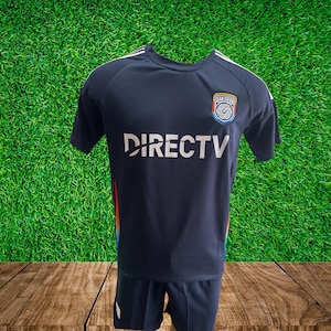 May include: Navy blue soccer jersey and shorts set. The jersey features the DIRECTV logo in white, a San Diego team emblem, and white stripes on the shoulders. The side of the jersey has a colorful stripe design.