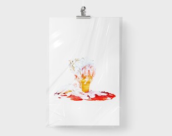 May include: A print of a melting ice cream cone on a white background. The cone is yellow, with white and pink ice cream spilling onto a red puddle. The print is wrapped in clear plastic and hung by a silver clip.