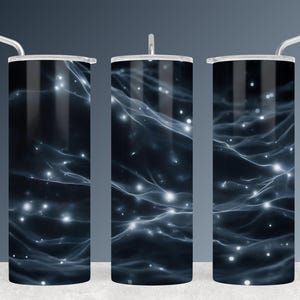 May include: Three stainless steel insulated tumblers with lids and straws. The tumblers feature a dark blue and white abstract design with a starry, nebula-like pattern. The design wraps around the entire body of the tumblers.