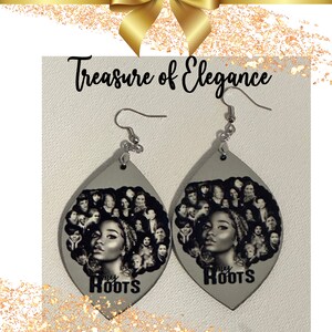 May include: A pair of gray teardrop-shaped earrings with silver hooks. Each earring features a black and white photo collage of women's faces with the text "My Roots" printed below the collage.