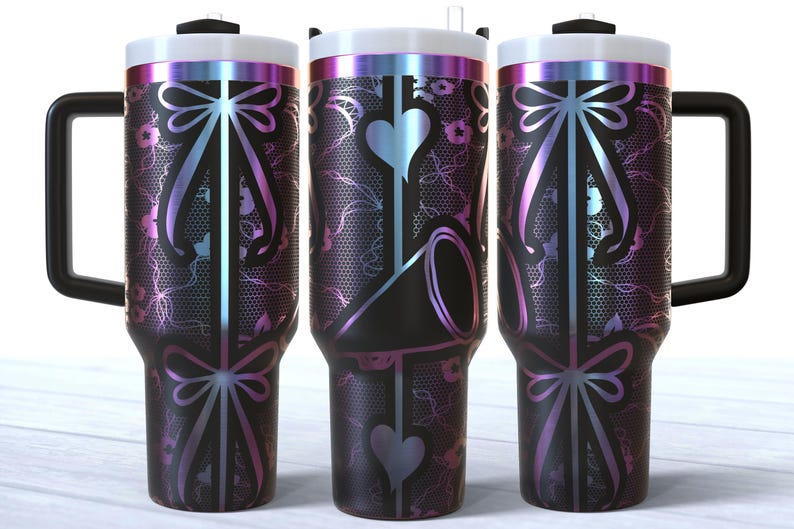 May include: Three stainless steel tumblers with a black and iridescent finish. The tumblers feature a design of a bow with a lace pattern.