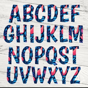 May include: A colorful alphabet with each letter filled with a blue and pink floral pattern on a white wood background.