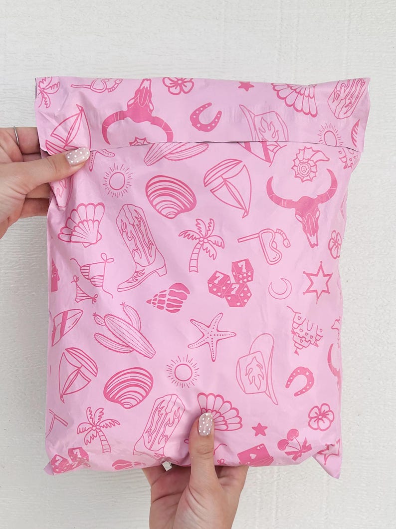 May include: Pink poly mailer with a repeating pattern of pink and white illustrations of various summer and western themed icons, including palm trees, seashells, horseshoes, and cacti.