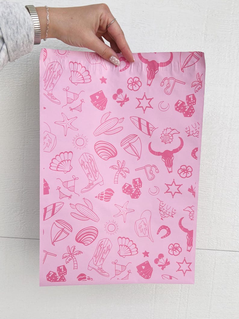 May include: Pink poly mailers with a repeating pattern of pink cowboy boots, seashells, surfboards, stars, cacti, and other western and beach themed icons.