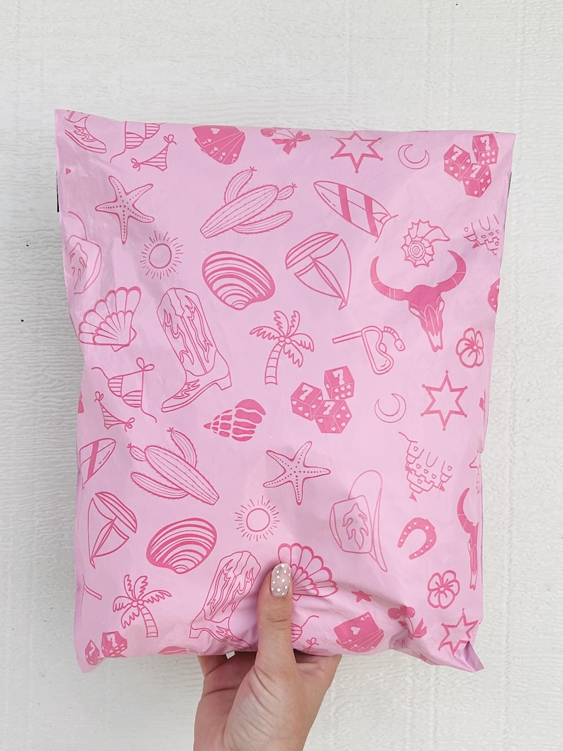 May include: Pink poly mailer with a repeating pattern of pink line drawings of various icons including a cactus, a surfboard, a cowboy boot, a seashell, a palm tree, a horseshoe, a star, a crescent moon, and dice.