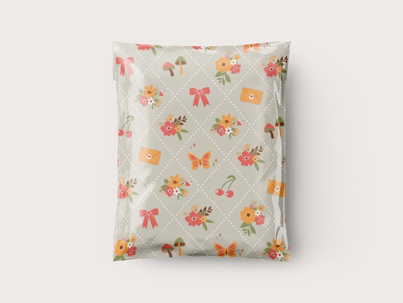 May include: A plastic mailing envelope with a light gray background and a repeating pattern of flowers, cherries, mushrooms, butterflies, and envelopes with hearts.
