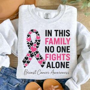 In This Family No One Fights Alone Breast Cancer Sweatshirt, Breast Cancer Awareness Shirt, In October We Wear Pink Shirt, Fighters Gifts