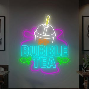 May include: A neon sign for bubble tea. The sign features a bubble tea cup with a straw, orange boba, and the words "BUBBLE TEA" in bright teal. The sign is outlined in pink and green, with a white background.