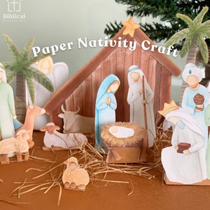 May include: A paper nativity scene craft set, including a stable, figures of Mary, Joseph, baby Jesus, and the Three Wise Men. The scene features palm trees, sheep, and an angel. The text "Paper Nativity Craft" is displayed.