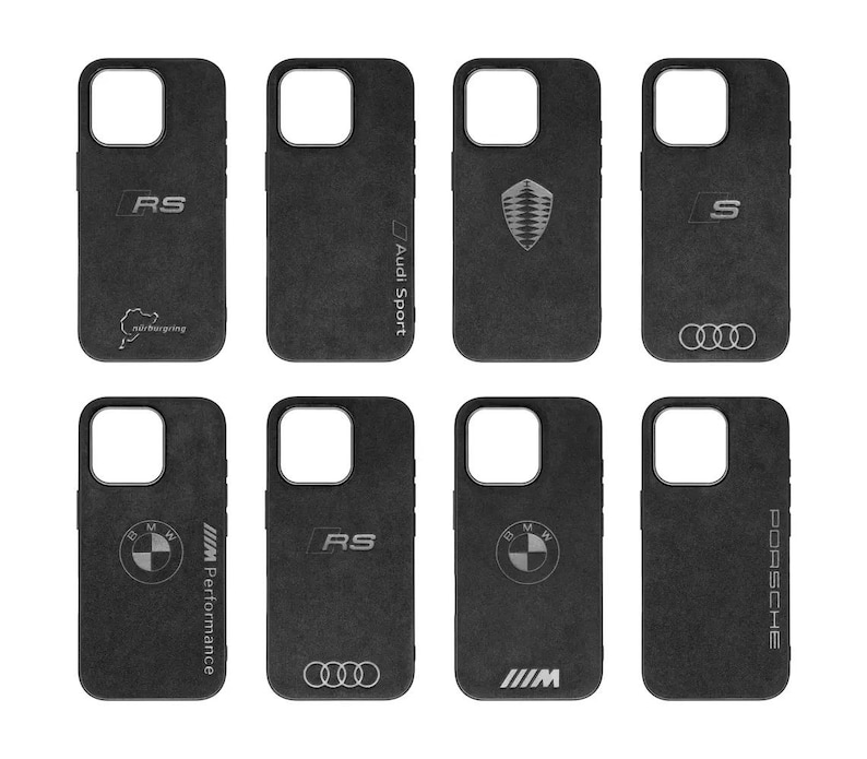 May include: Nine different phone cases featuring various logos and branding. The cases are black with a suede-like texture. The logos include Audi Sport, RS, S, BMW Performance, and Porsche.