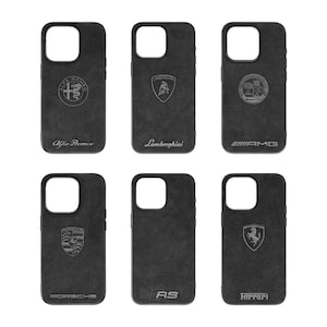 May include: Six black phone cases featuring different car logos. The logos are Alfa Romeo, Lamborghini, AMG, Porsche, RS, and Ferrari.