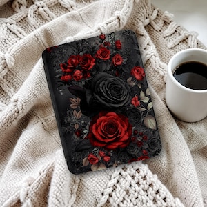 May include: A rectangular e-reader case featuring a dark, moody floral print with deep red and black roses against a charcoal background. The design includes intricate petals, leaves, and stems, creating a dense, layered botanical pattern across the surface.