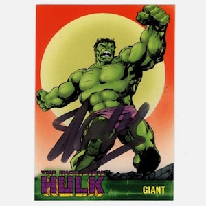 May include: A trading card featuring the Hulk, a green-skinned superhero, in a dynamic pose with a raised fist. The background includes a yellow circle and a red sky. The card has the text "THE INCREDIBLE HULK" and "GIANT".