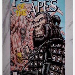 May include: Comic book cover for "Planet of the Apes" with a gorilla in armour. The title is in large white letters on a blue background. The cover art includes other ape-like figures and the text "Book One" and "Adventure".