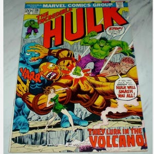May include: Vintage comic book cover of The Incredible Hulk. The cover features a dynamic illustration of the Hulk in action, with vibrant colors and bold lettering. The Hulk is depicted in a battle scene with other characters, with the text "THEY LURK IN THE VOLCANO!"