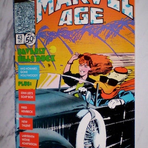 May include: Marvel Age comic book cover featuring a car with a woman and Howard the Duck. The cover has the text "Marvel Age" and "Beverly Hills Duck". The comic is marked with "43 Oct 50¢".
