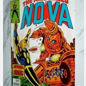 May include: A vintage comic book titled "The Man Called Nova" from Marvel Comics Group. The cover features a superhero in a yellow and blue suit battling a large, orange robot. The comic has the text "Evil is the Earth Shaker!"