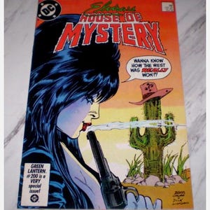 May include: Comic book cover for "Elvira's House of Mystery" showing a woman with black hair holding a gun. The cover has the text "Wanna know how the West was REALLY won?!" and "Green Lantern #200 is a very special issue!"