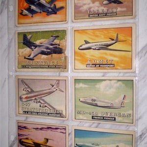 May include: A collection of vintage airplane trading cards, each featuring a different aircraft. The cards are displayed in a clear plastic sheet. The cards include the "AM MAULER", "FIREFLY", "AJ SAVAGE", "COMET", "C-97 STRATOFREIGHTER", "MD-450 OURAGAN", "AE-55 PULQUI", and "SO-6021 ESPADAN".