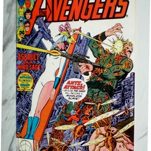 May include: A vintage Marvel Comics Group The Avengers issue 195 comic book featuring a colorful cover illustration of The Wasp and Ant-Man battling a soldier surrounded by ants, with the text Assault on a Mind Cage and Ants, Attack!