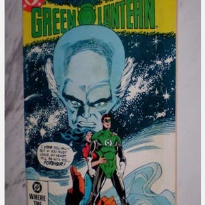 May include: A vintage comic book cover for Green Lantern, featuring a large blue-skinned character and Green Lantern in a green and black suit. The cover includes text that reads "RESOLUTIONS IN THIS GREEN LANTERN" and "WHERE THE ACTION IS!"
