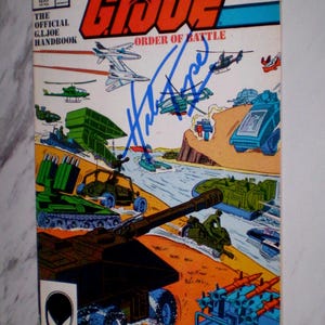 May include: Marvel G.I. Joe #4 comic book. The cover features a colorful illustration of military vehicles, aircraft, and soldiers in action. The title "The G.I. Joe Order of Battle" is prominently displayed. Includes the text "Marvel" and "The Official G.I. Joe Handbook".
