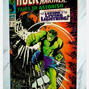 May include: A vintage comic book cover featuring the Hulk and Prince Namor, the Sub-Mariner. The cover art shows the Hulk in action, with the text "Tales to Astonish" and "Introducing: The Legion of the Living Lightning!" displayed prominently. The comic is labeled Marvel Comics Group.