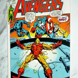 May include: A vintage Marvel Comics Group Avengers issue 106 comic book featuring a cover illustration of Iron Man lying on the ground while Black Panther, Captain America, and Hawkeye look on. The text reads Avengers, Earth's Mightiest Heroes, and A Traitor Stalks Among Us.
