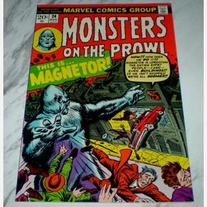 May include: A vintage comic book cover for "Monsters on the Prowl" with a large, blue monster as the central figure. The cover includes the text "This is Magnetor!" and "Marvel Comics Group." The artwork shows a city scene.