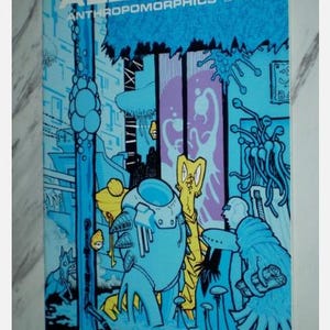 May include: Comic book cover titled "Albedo Anthropomorphics" with a futuristic, science fiction theme. The artwork features various alien creatures in shades of blue, yellow, and purple, set against a cityscape backdrop. The comic is issue number 13.