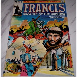 May include: A vintage comic book titled "Francis Brother of the Universe" by Marvel Comics Group. The cover features colourful illustrations of a man, a knight on horseback, and various scenes. The price is 75 cents.