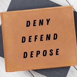May include: A brown leather wallet with the words "DENY DEFEND DEPOSE" printed in black.