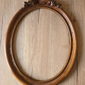 Old carved wooden frame in Louis XVI style.