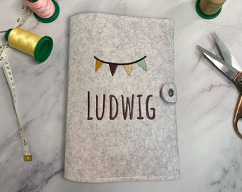 Personligt omslag till barnjournal - Filtomslag till barnjournal med broderat namn och motiv