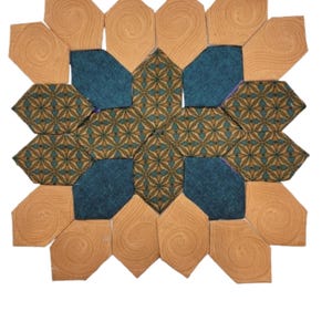May include: A geometric patterned fabric wall hanging with a teal blue and gold design. The fabric is sewn together in a starburst pattern with a brown border.
