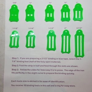 May include: A set of ten bright green Easy Binding and Bias Tape Tools, with sizes from 1/8" to 2-1/2". The tools are labeled with their sizes and instructions are included. The tools are designed to help with preparing binding or bias tape.