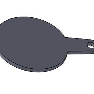 Può includere: Un bersaglio di metallo grigio con un centro rotondo e un manico sul lato.