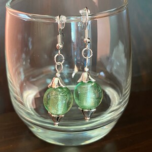 Light green glass and silver floral capped earrings