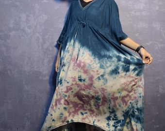 May include: A long, blue and white tie-dye dress with a white hat and beige heeled sandals.
