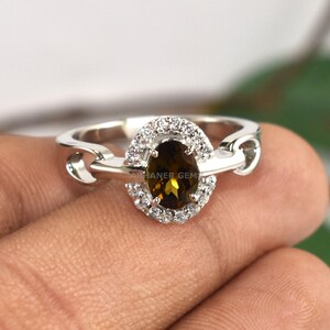 May include: A rustic wooden sign with the text "Welcome to our home" in white lettering. The sign features a distressed finish and a simple, inviting design, perfect for front door decor.