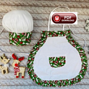 May include: A white chef's hat and apron set with a green Christmas-themed pattern. The apron has a white front and pocket, with a ruffled hem. The image also includes wooden reindeer decorations and a "PDF DOWNLOAD" graphic.