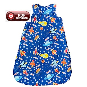 May include: A sleeveless blue baby sleep sack with a space-themed pattern. The design includes rockets, planets, stars, and the words "PLAN", "COMET", and "SPACE". The sleep sack is designed for babies and toddlers.